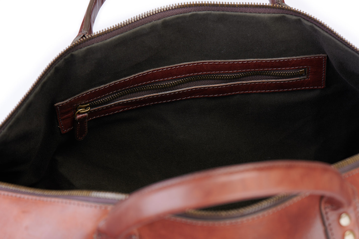 inside zipper pockets on big sur duffle bag in vintage brown green lining