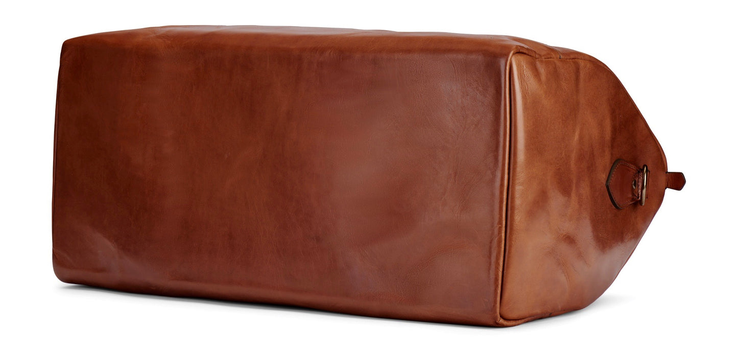 bottom of full grain vegetable tanned leather duffel in saddle tan