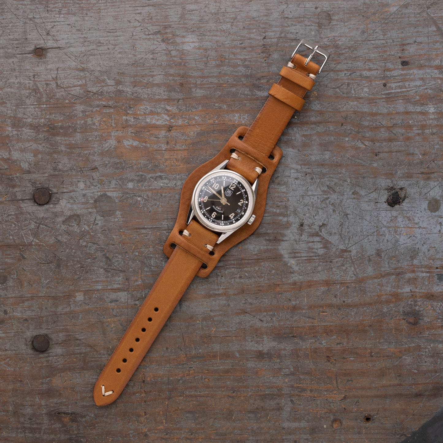 vintage Italian leather watch strap with bund pad by Jackson Wayne, pictured in saddle tan color with black watch